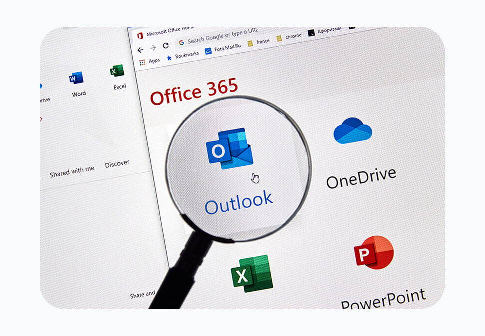Magnifying glass focusing on Outlook among four Microsoft 365 products